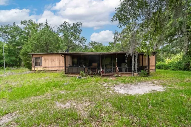 a view of a barn in the middle of a yard
