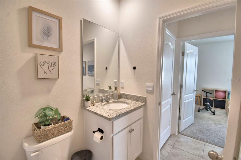 2839 Moulin Road Davenport, FL 33837 - Photo 23 of 75 a bathroom with a sink vanity and a mirror