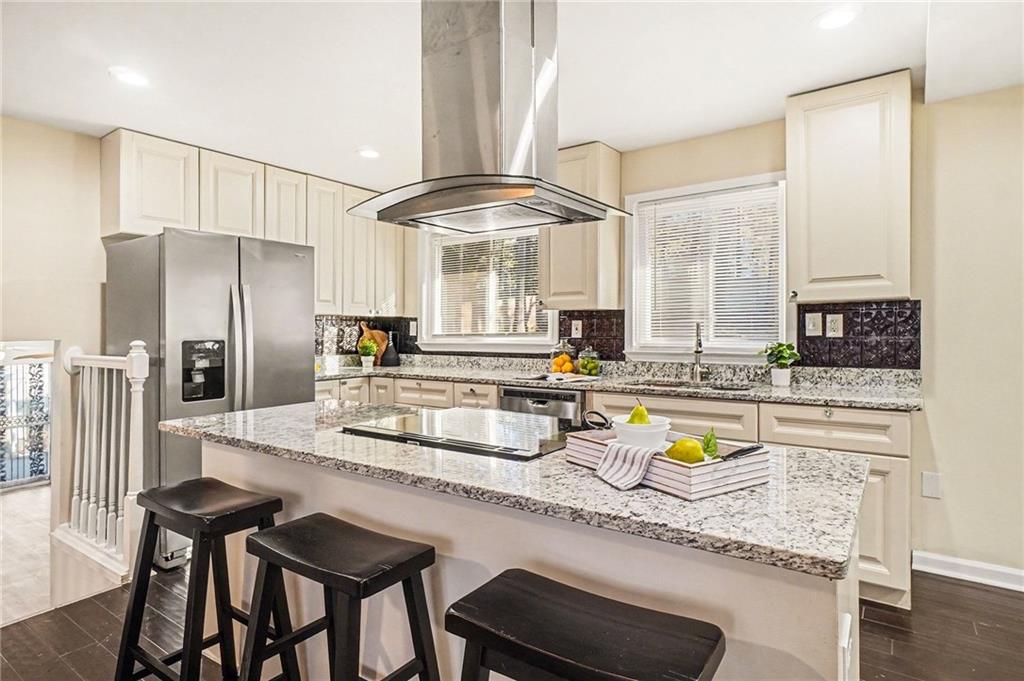 a kitchen with stainless steel appliances granite countertop a sink and cabinets