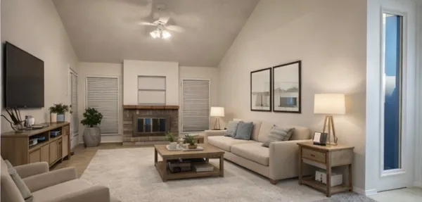 a living room with furniture a fireplace and a flat screen tv