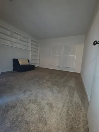 a view of an empty room and entryway