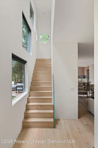 a view of entryway and hall with wooden floor