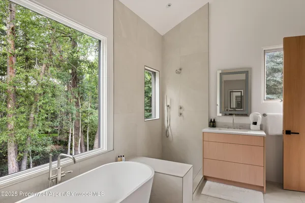 a bathroom with a sink toilet and mirror