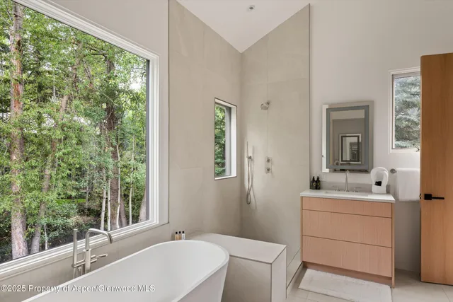 a bathroom with a sink toilet and mirror