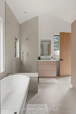 a bathroom with a sink a mirror and a bathtub