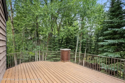 a balcony with wooden floor and fence