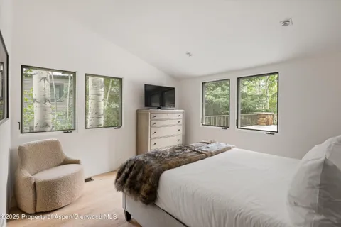 a bedroom with a bed and glass window