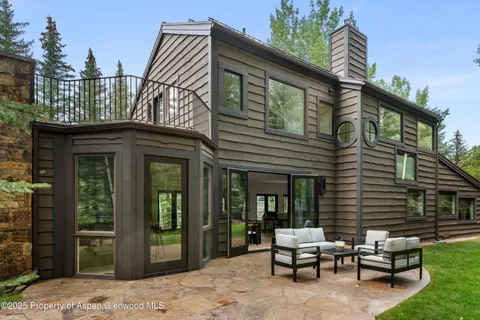 a view of a house with a patio and a yard