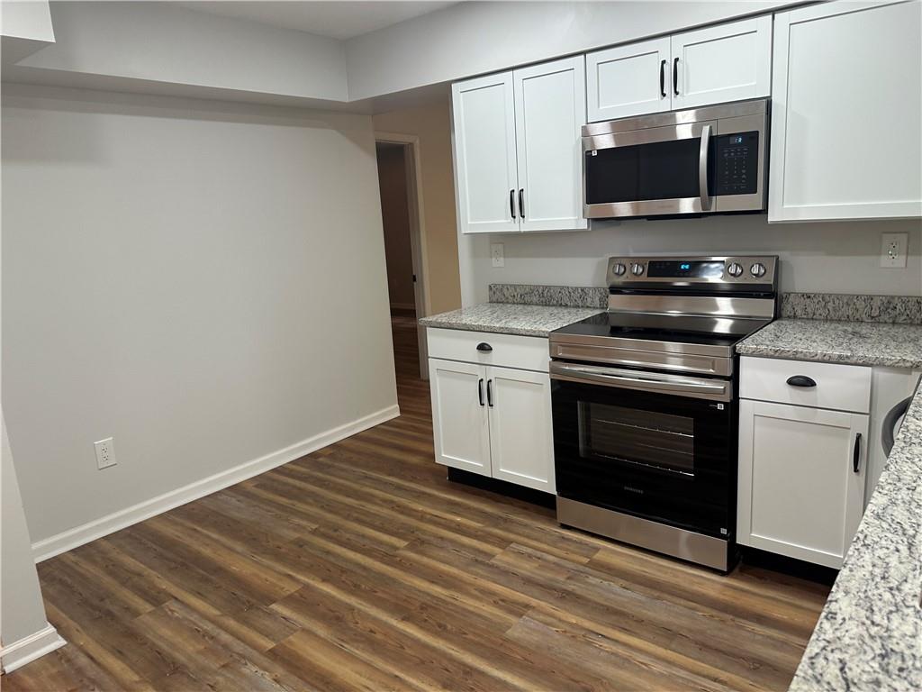 201 Clever Road McKees Rocks, PA 15136 - Photo 8 of 30 a kitchen with a stove and a microwave