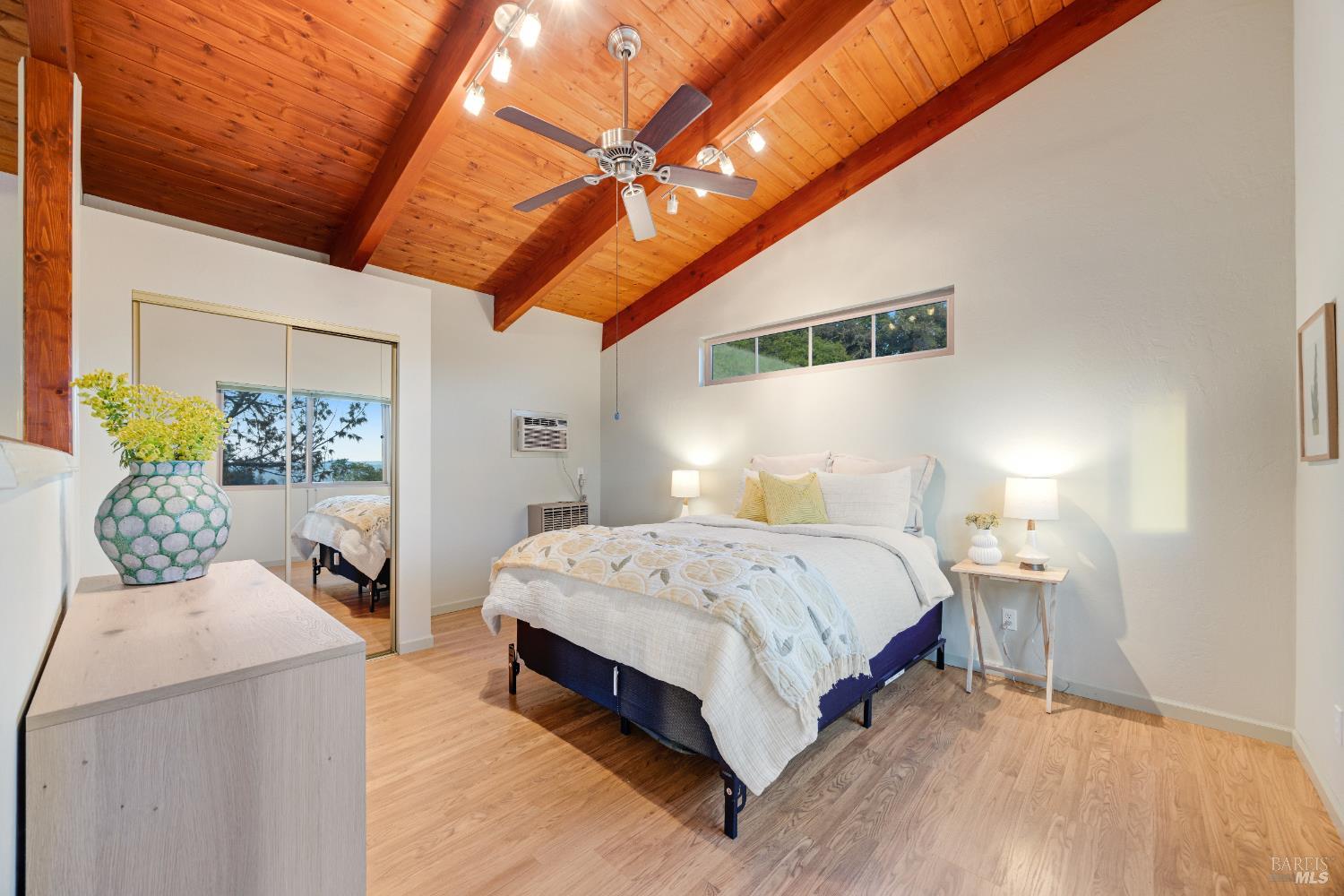 6960 Round Oak Road Penngrove, CA 94951 - Photo 35 of 58 a spacious bedroom with a bed and wooden floor