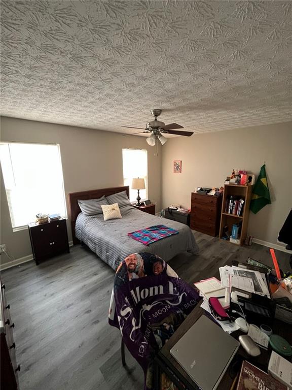 1915 Matthew Way Lithonia, GA 30058 - Photo 6 of 10 a bedroom with a bed and wooden floor