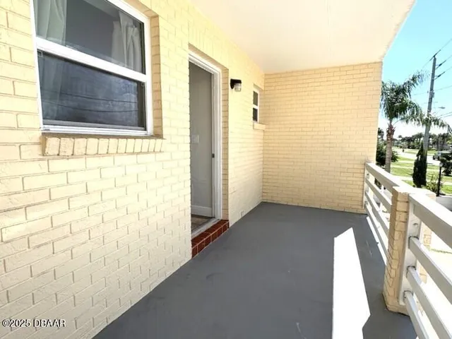 a view of a livingroom with a ceiling fan and window