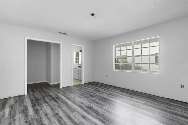 wooden floor in an empty room with a window