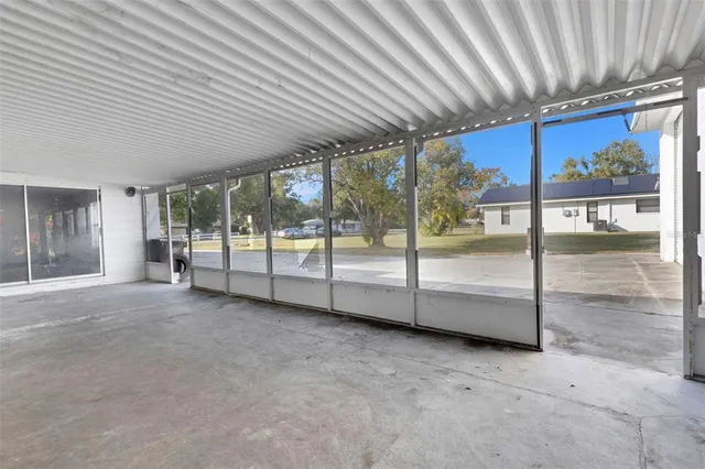 a view of an empty room with glass door
