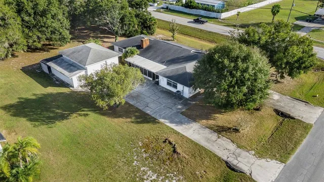 an aerial view of a house with yard swimming pool and outdoor seating