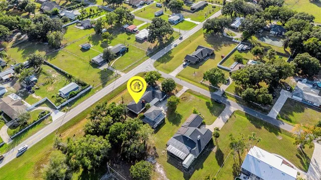 an aerial view of a house with a yard and garden