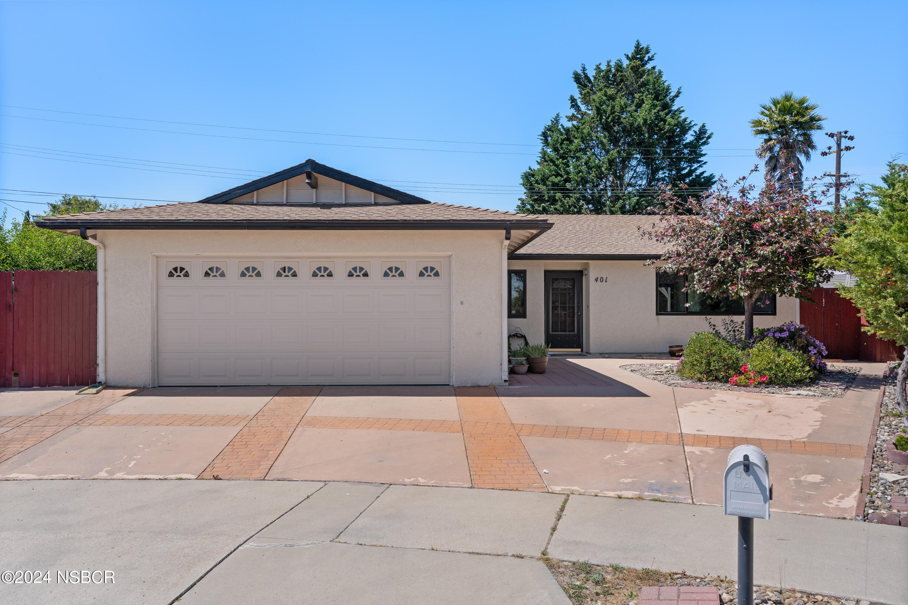 401 Mars Avenue Lompoc, CA 93436 - Photo 1 of 38 a front view of a house with a yard and garage
