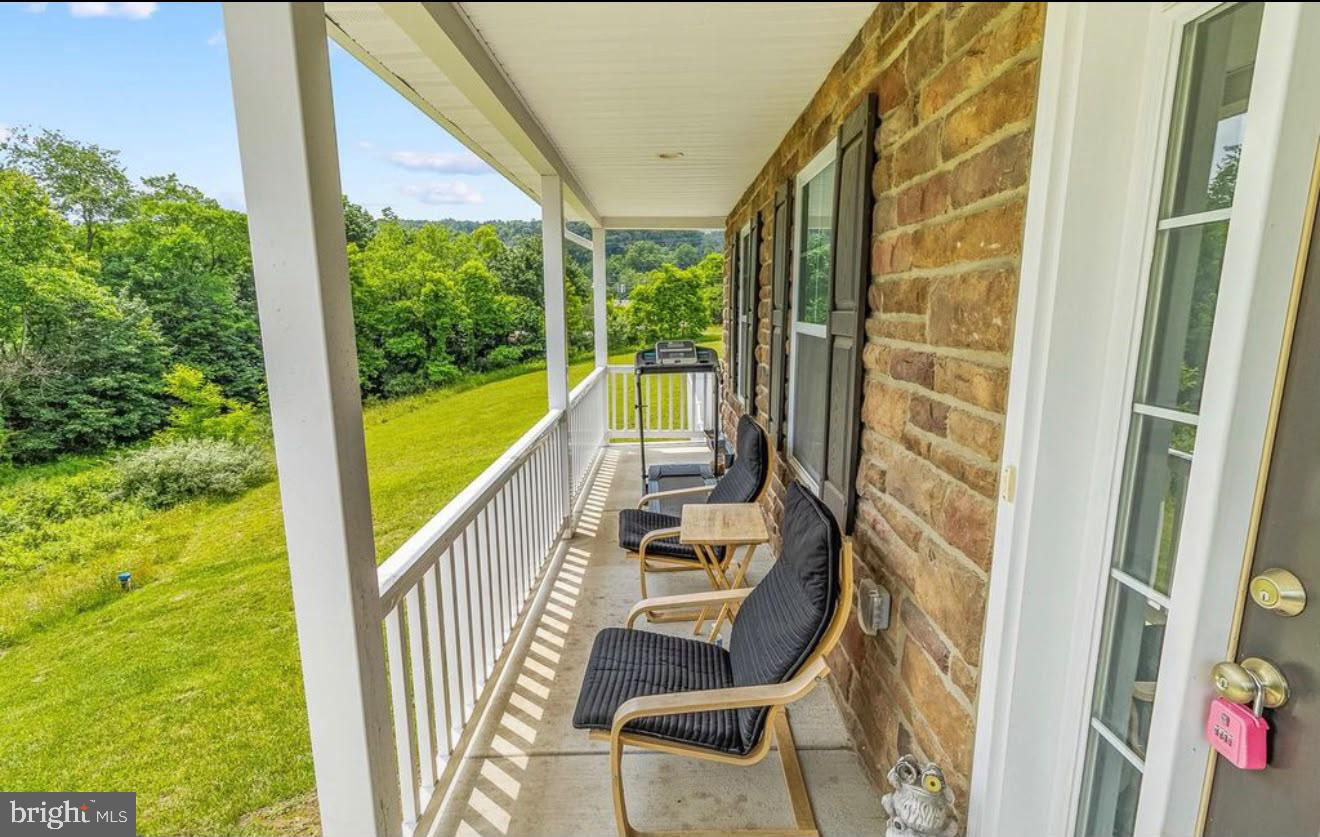 123 Hank Aaron Road Berkeley Springs, WV 25411 - Photo 8 of 32 Serene porch with lush green views.