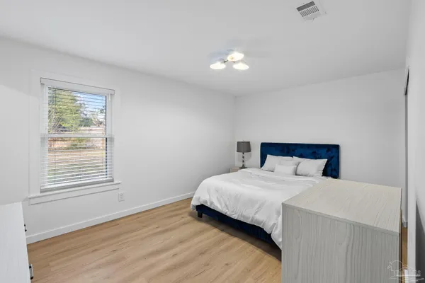 a bedroom with a bed and a window