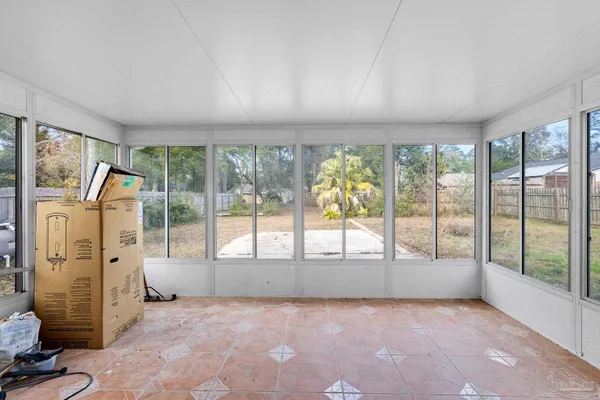 a view of an empty room with a fireplace and a large window