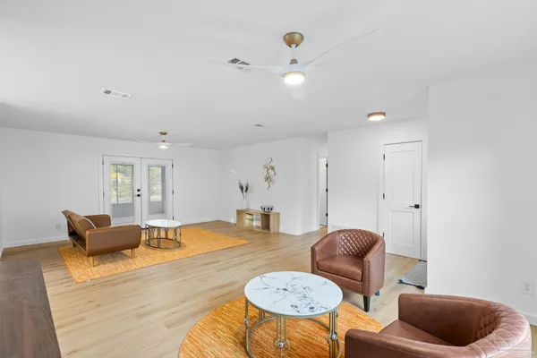 a living room with furniture and a lamp