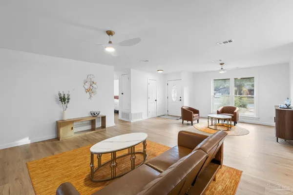 a living room with furniture and wooden floor