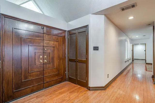 a view of a hallway with wooden floor