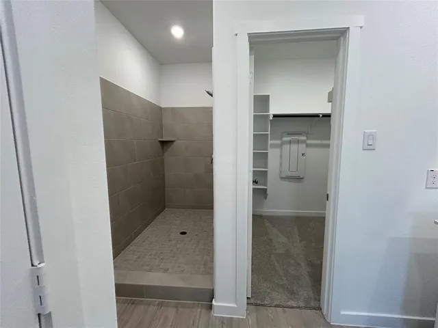 a view of kitchen with kitchen island stainless steel appliances refrigerator stove microwave and cabinets