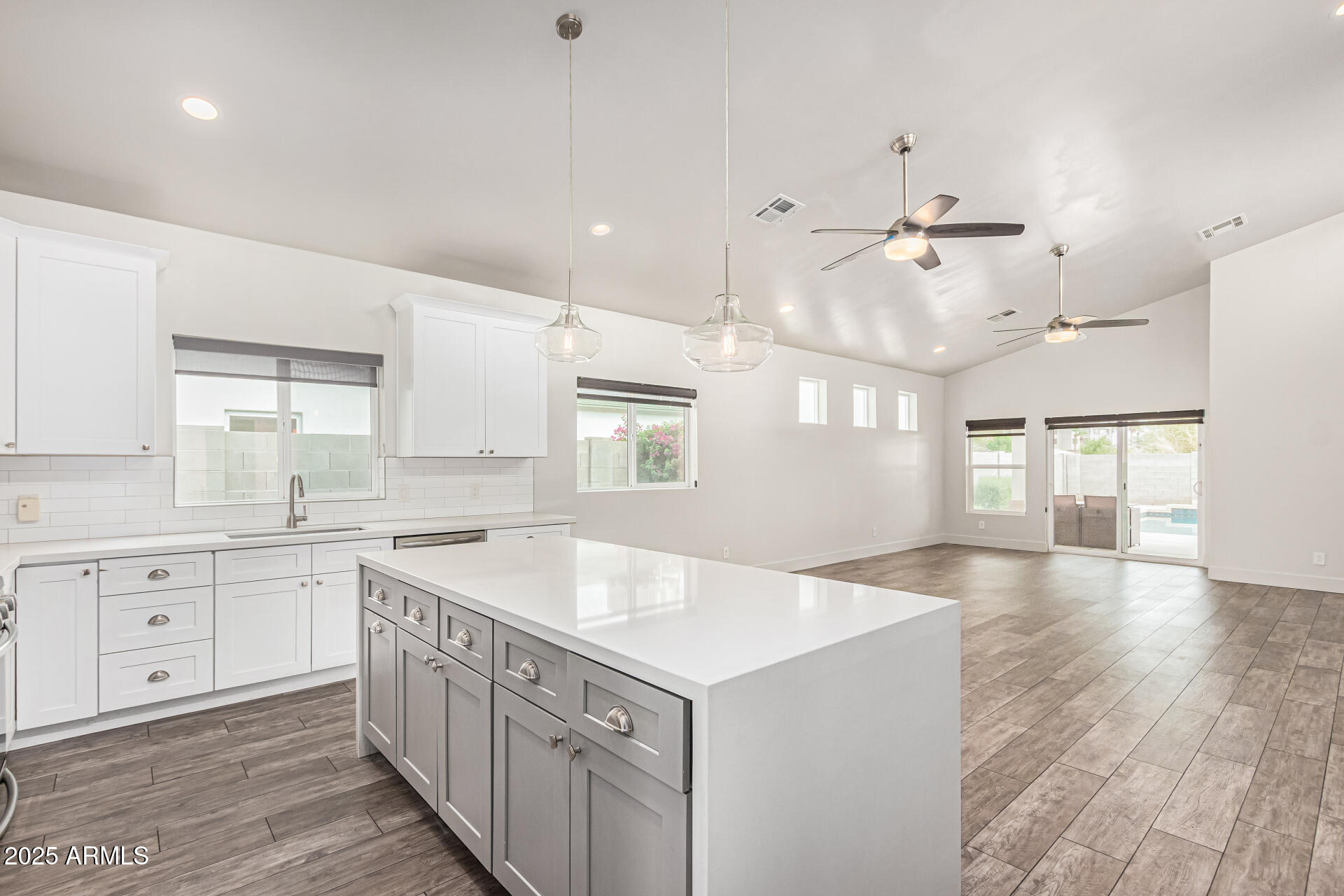 1005 East Weldon Avenue Phoenix, AZ 85014 - Photo 6 of 21 a kitchen with stainless steel appliances granite countertop a sink a stove and a wooden floors