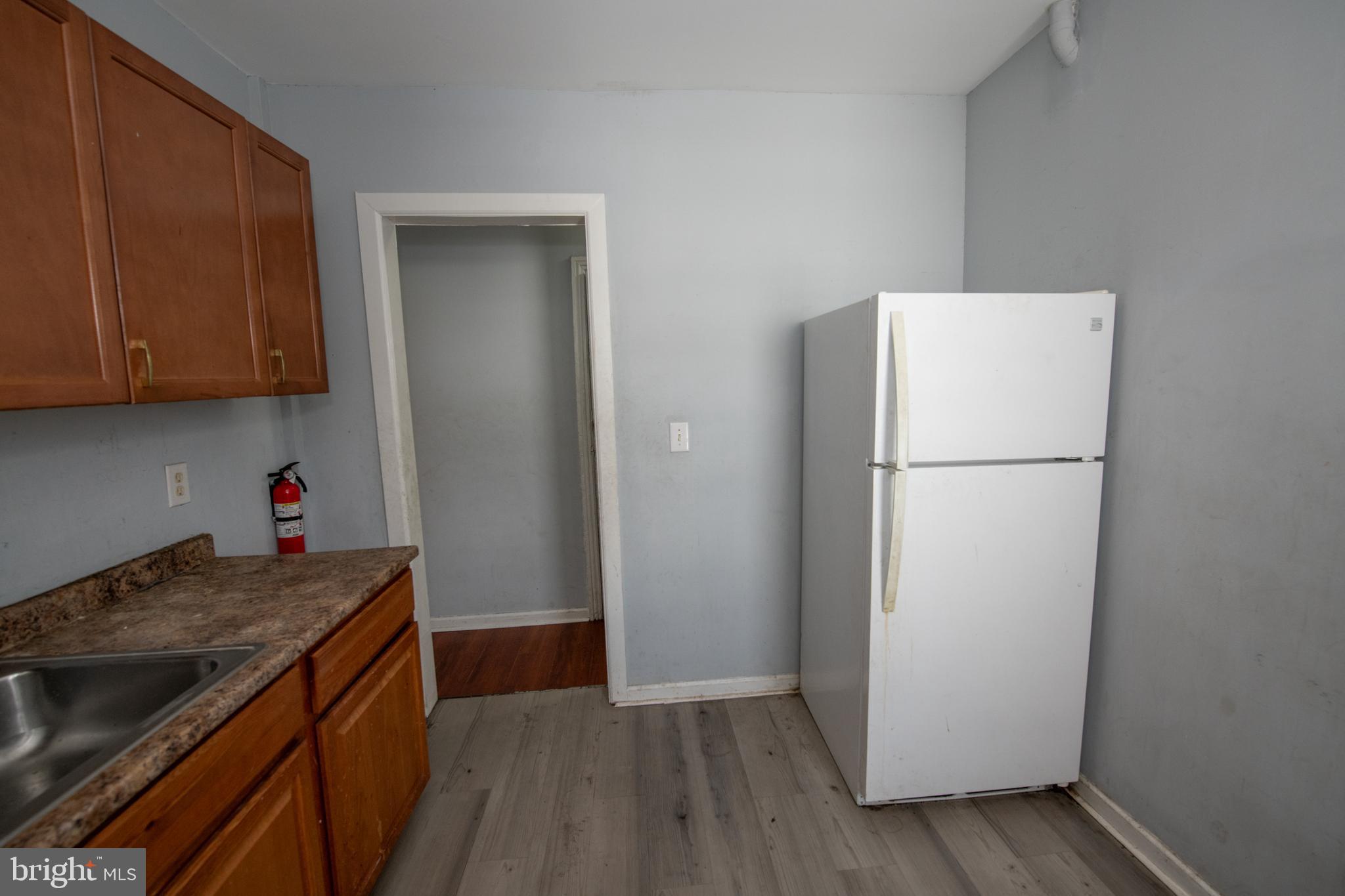 805 Prospect Street Trenton, NJ 08618 - Photo 21 of 31 a kitchen with a refrigerator and a stove top oven