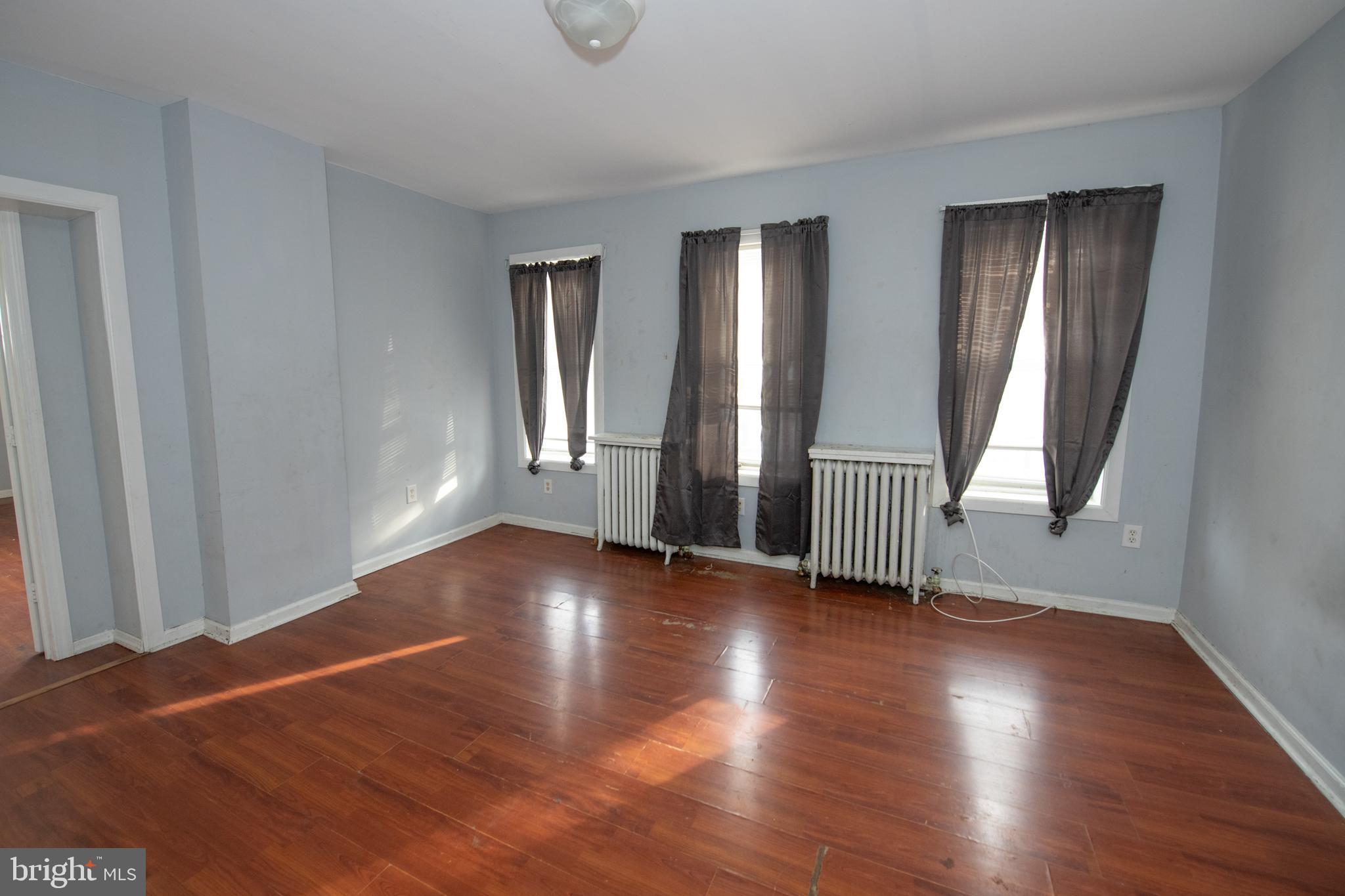 805 Prospect Street Trenton, NJ 08618 - Photo 29 of 31 an empty room with wooden floor and windows