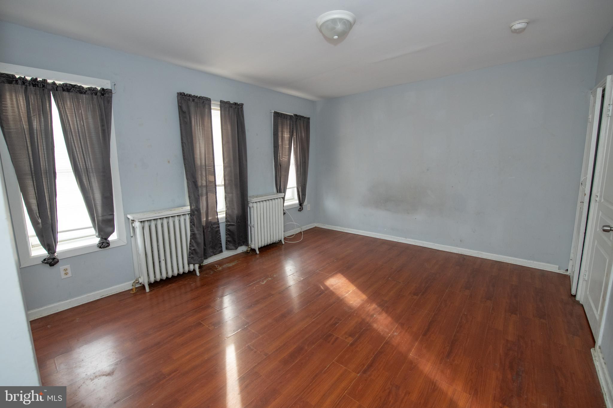 805 Prospect Street Trenton, NJ 08618 - Photo 30 of 31 an empty room with wooden floor and windows