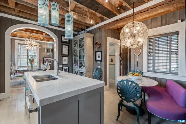 a dining room with furniture a wooden floor and a chandelier