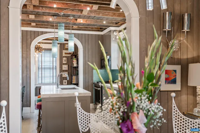 a bedroom with a large bed a flat tv screen and a dresser