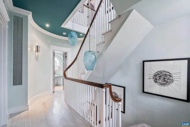 a room with a table chairs and a large window