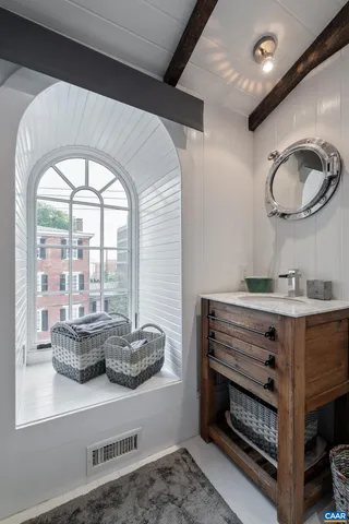 a en suite bathroom with a granite countertop sink mirror and vanity