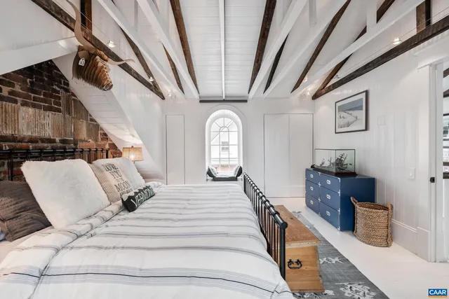 a view of staircase with railing and chandelier