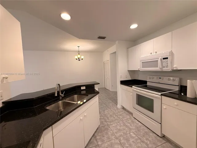 a kitchen that has a sink and a stove