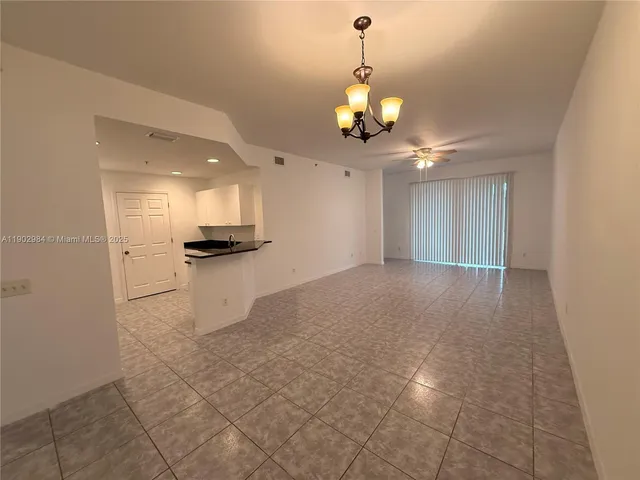 a view of a kitchen with a sink and stainless steel appliances