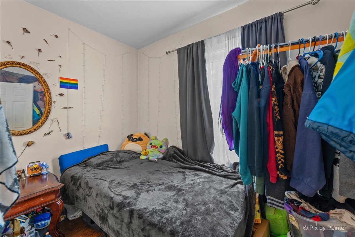 58 South Geneva Street Elgin, IL 60120 - Photo 11 of 24 a bed room with a bed and a walk in closet
