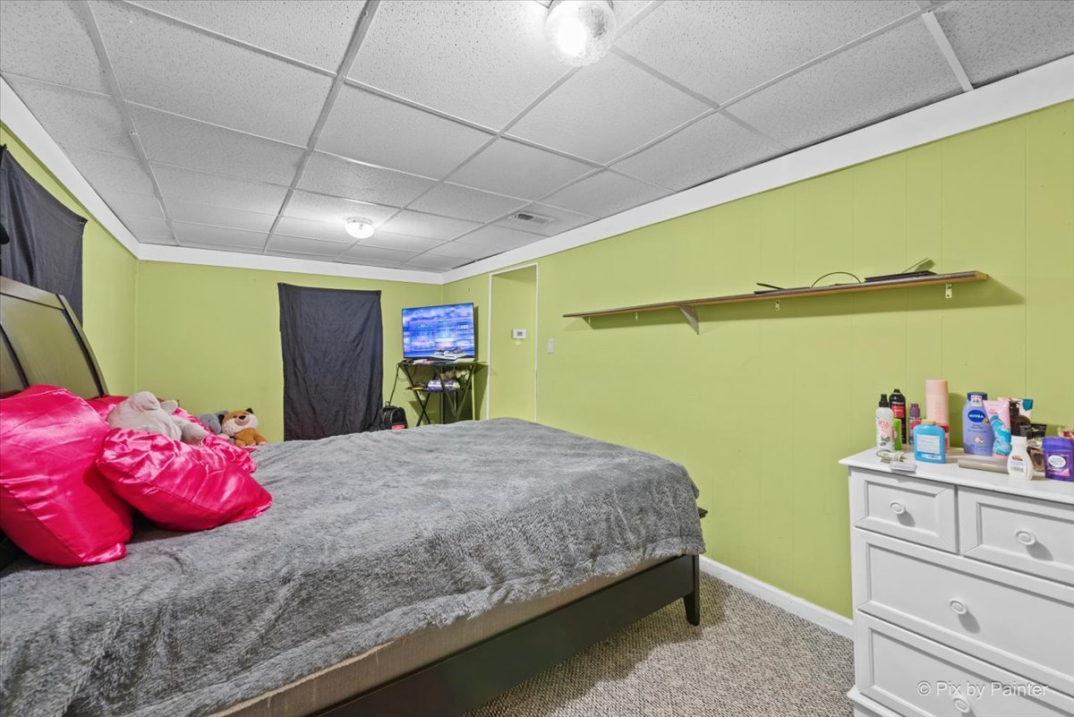 58 South Geneva Street Elgin, IL 60120 - Photo 14 of 24 a bedroom with a bed and a walk in closet