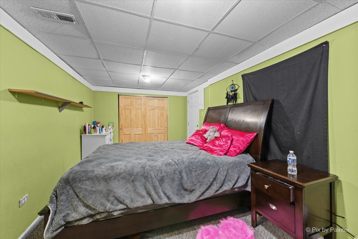 58 South Geneva Street Elgin, IL 60120 - Photo 15 of 24 a bed sitting in a bedroom next to a window
