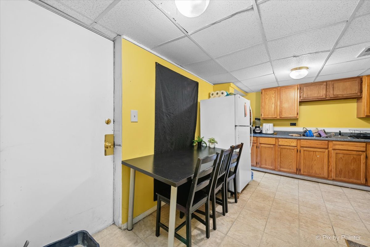 58 South Geneva Street Elgin, IL 60120 - Photo 16 of 24 a kitchen with a table and chairs in it