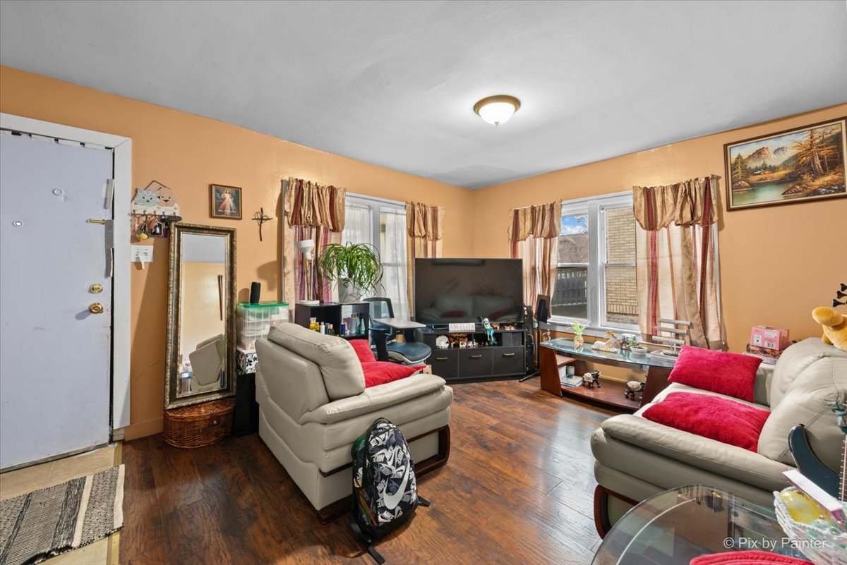 58 South Geneva Street Elgin, IL 60120 - Photo 5 of 24 a living room with furniture flat screen tv and a large window