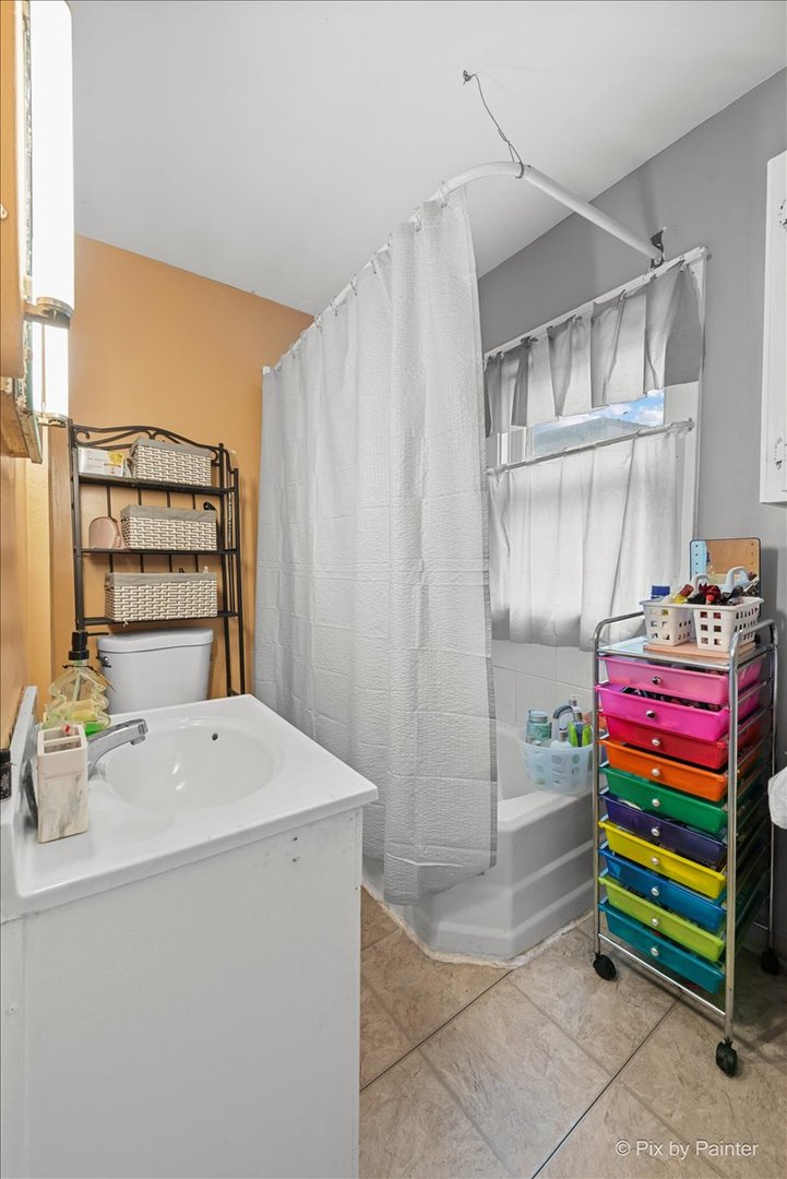 58 South Geneva Street Elgin, IL 60120 - Photo 10 of 24 a room with a baby crib and a wooden floor