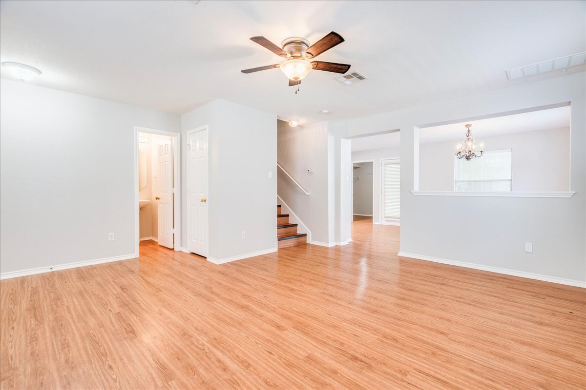 1507 Davis Mountain Loop Cedar Park, TX 78613 - Photo 7 of 30 Spacious living area featuring wood-finish flooring, a ceiling fan with integrated lighting, and neutral wall tones