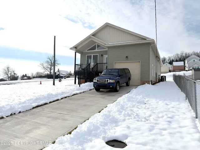 a view of a house with a snow in the yard