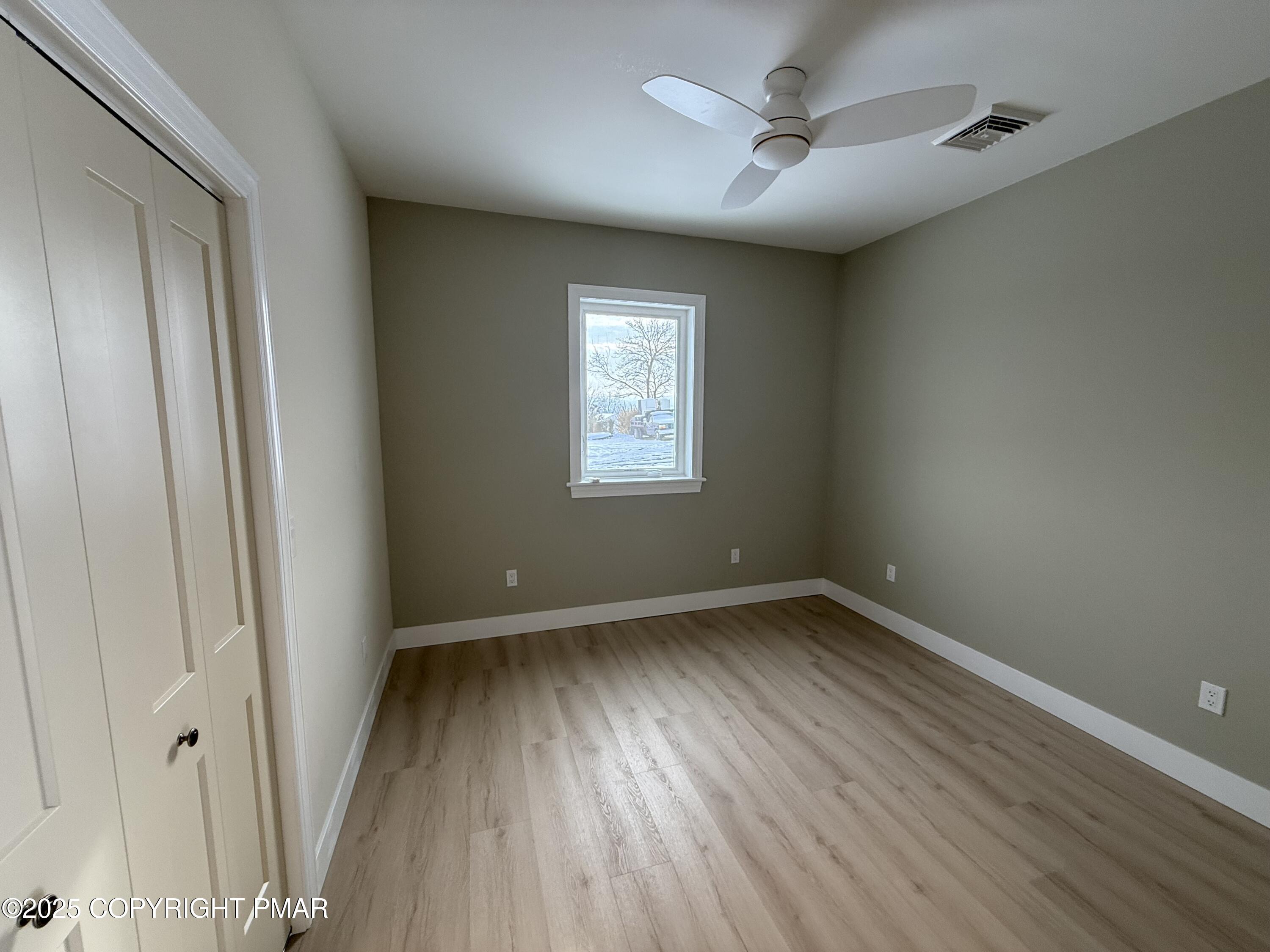 1270 Franklin Street Old Forge, PA 18518 - Photo 15 of 30 an empty room with wooden floor and windows