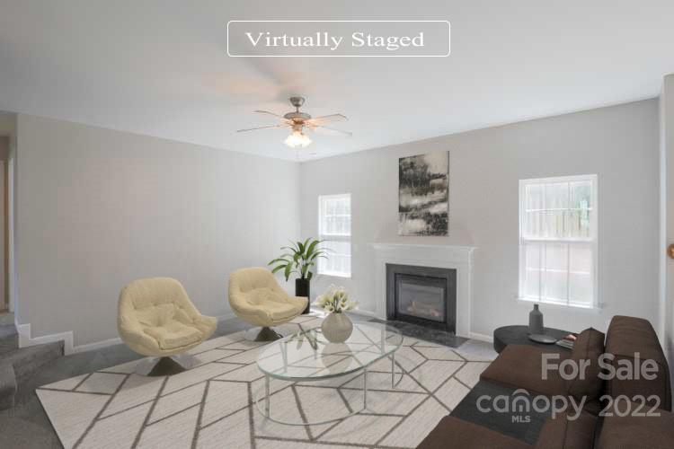 328 Wellridge Drive Fort Mill, SC 29708 - Photo 2 of 23 a living room with furniture flowers and a fireplace
