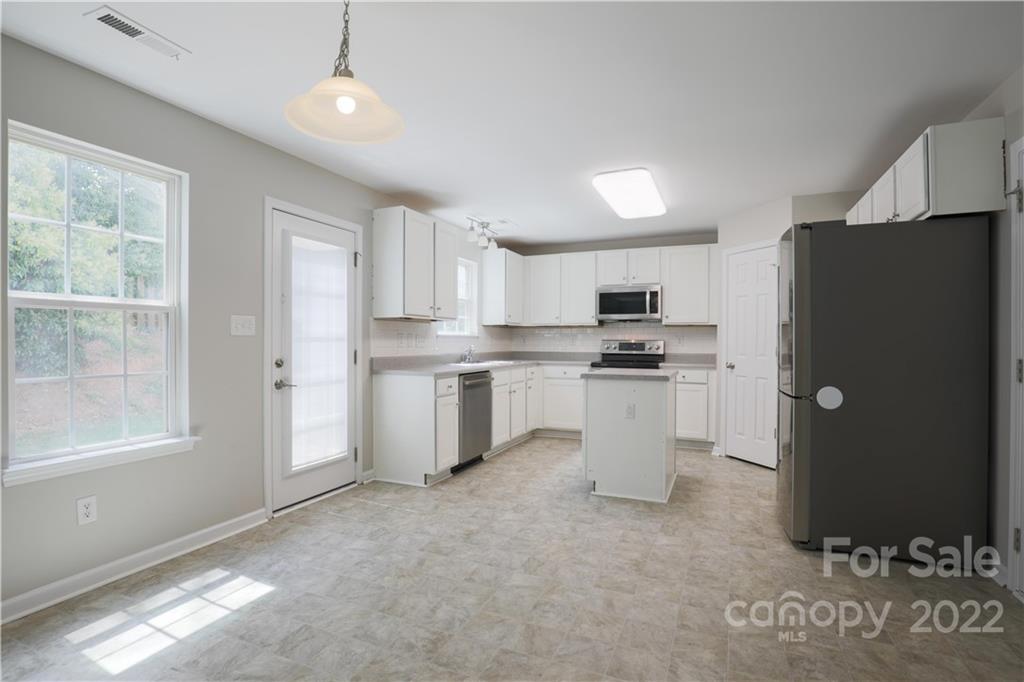 328 Wellridge Drive Fort Mill, SC 29708 - Photo 6 of 23 a kitchen with white cabinets and refrigerator